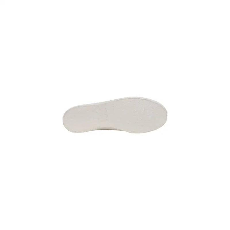 White rubber sole of tommy hilfiger men’s beige slip on cotton sneakers with smooth slightly textured surface