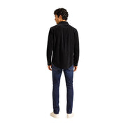 Tommy Hilfiger Chemise homme noire en velours côtelé noir à manches longues et boutons, en coton biologique (vue de face)