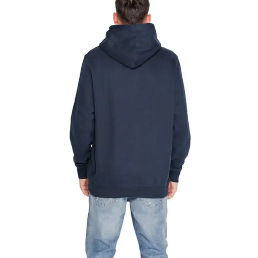 Tommy Hilfiger Men Navy Blue Hooded Sweatshirt worn by person facing away