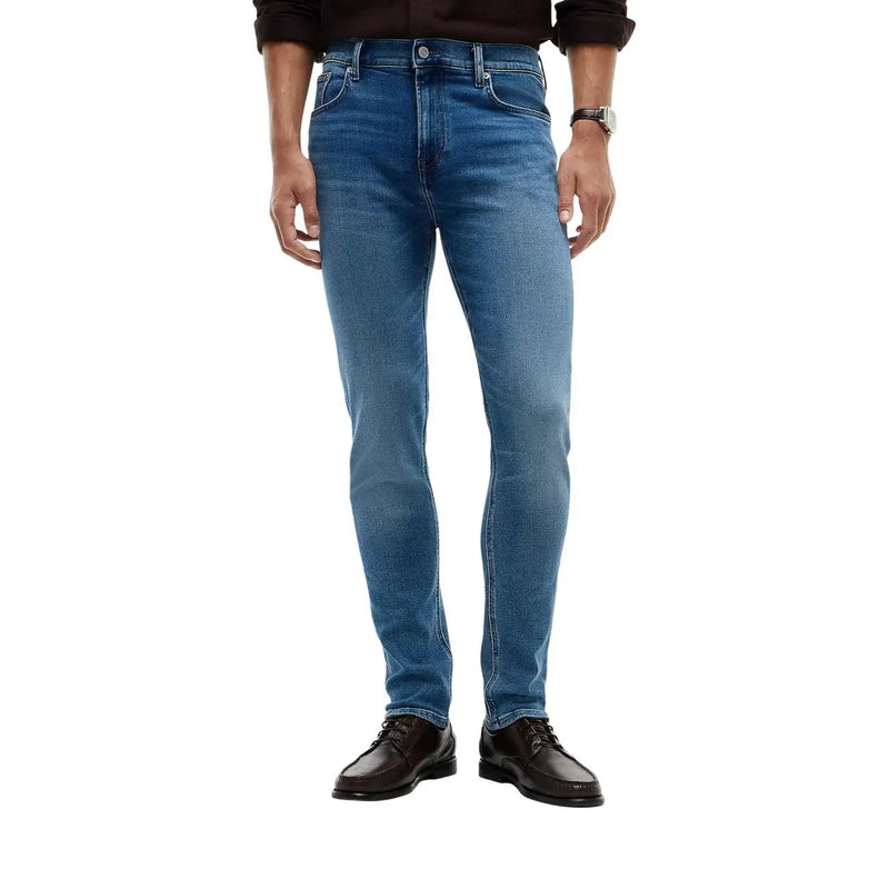 Tommy Hilfiger Jean slim Bleecker pour homme en denim bleu avec un design classique à cinq poches et un délavage subtil sur le devant