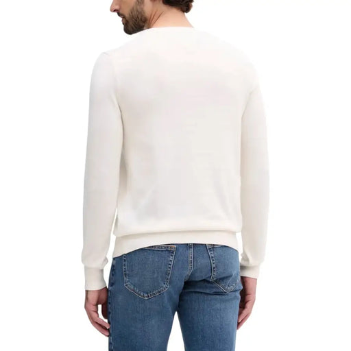 Cream-colored crew neck sweater with ribbed cuffs and hem, likely made of cotton or a similar soft fabric.