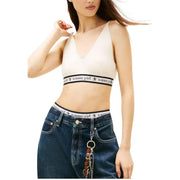 Cream-colored tommy girl bralette with black elastic band and star logo paired with tommy hilfiger white sleeveless v neck knit top for women