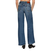 Blue denim women jeans by Tommy Hilfiger shown from the back with a brown leather belt loop and classic pockets