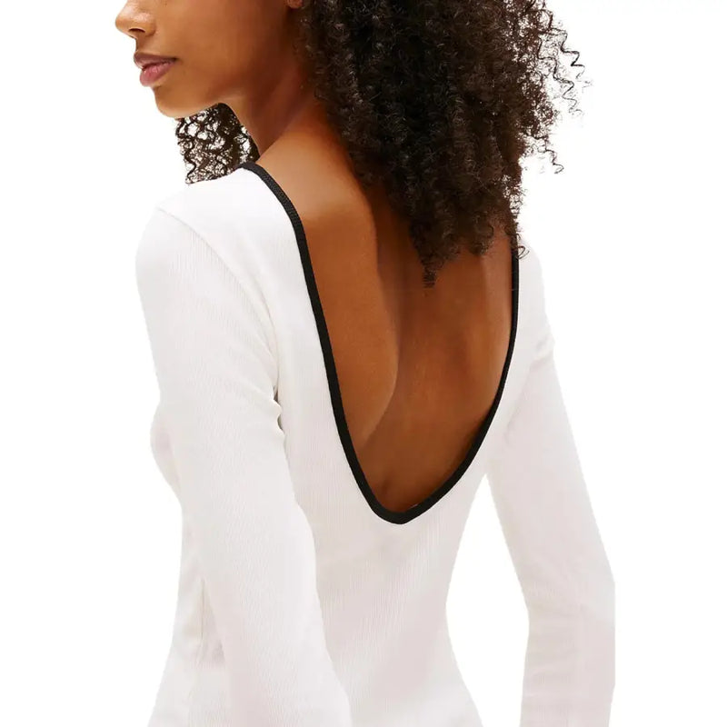 Back view of tommy hilfiger women white ribbed long sleeve organic cotton t-shirt with black trim on neckline