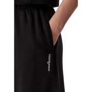 Pantalon de survêtement Tommy Hilfiger pour femme, en coton noir à jambes larges, avec texture côtelée et logo discret brodé en blanc sur la couture latérale.