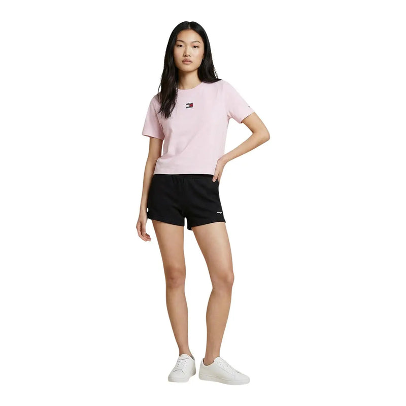 Pink short-sleeved tommy hilfiger t-shirt with small chest logo paired with black organic cotton women’s shorts