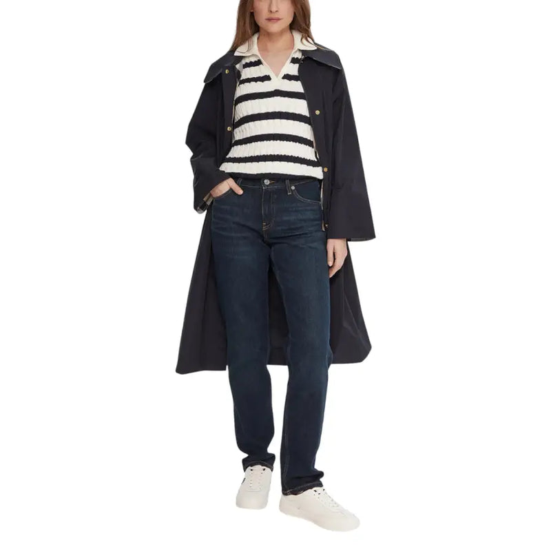 Black trench coat with gold-tone buttons and cream collar styled with tommy hilfiger women’s blue organic cotton jeans