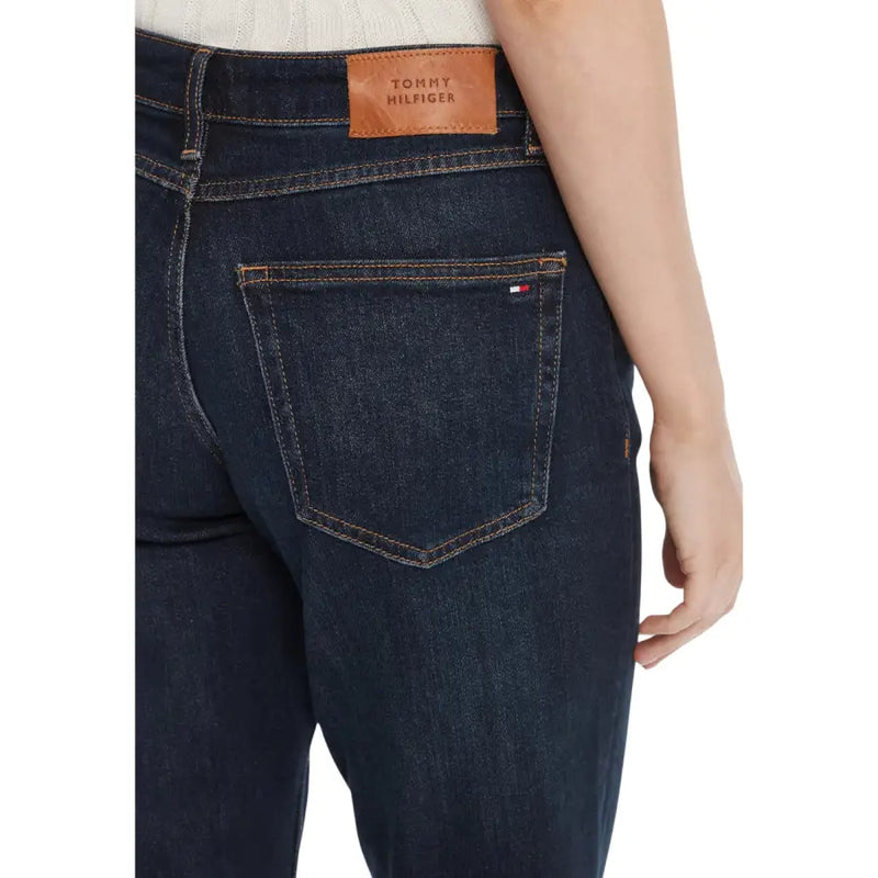 Back side of dark blue tommy hilfiger women’s organic cotton jeans with brown leather brand patch and flag logo embroidery