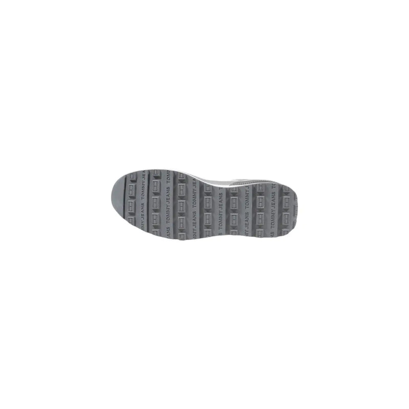 Gray rubber sole with repeating tommy jeans logo pattern on tommy hilfiger women’s grey leather sneakers