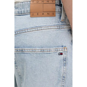Back side of tommy hilfiger women’s light blue ripped jeans in light-wash denim with tan leather label and flag logo