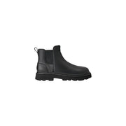 Bottes Chelsea Ugg pour homme en cuir noir, style classique, avec empiècements élastiques latéraux et semelle épaisse en caoutchouc.