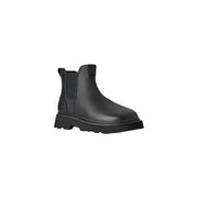 Bottines Chelsea Ugg pour homme en cuir noir, style classique, avec semelle épaisse en caoutchouc et empiècements élastiques latéraux.