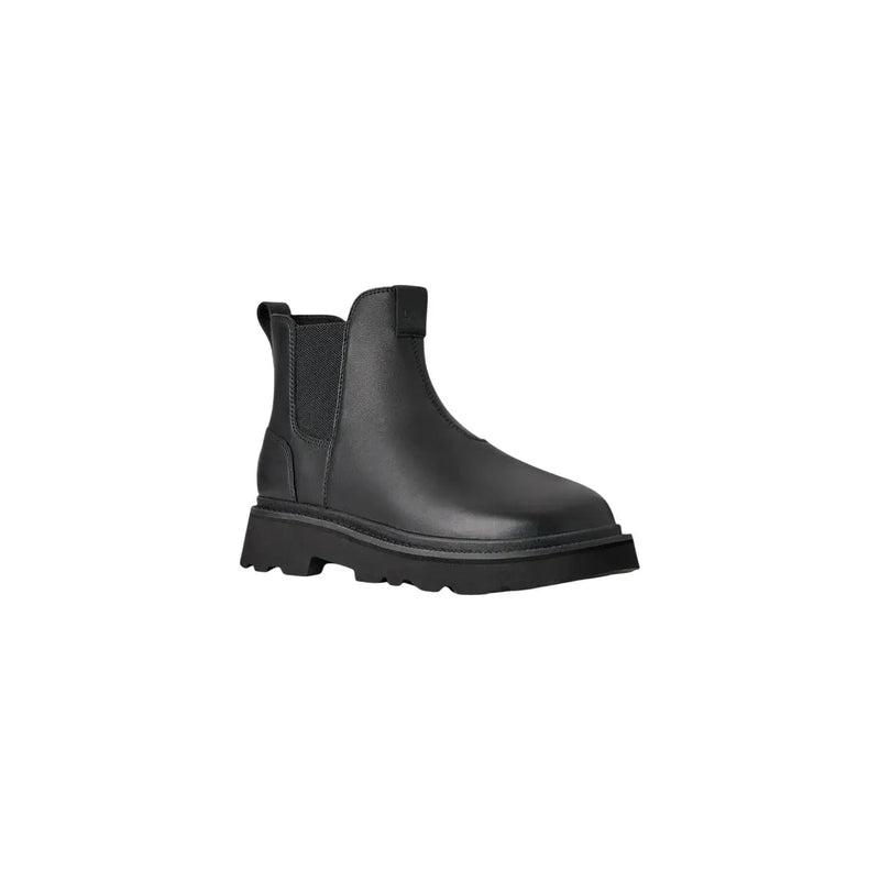 Bottines Chelsea Ugg pour homme en cuir noir, style classique, avec semelle épaisse en caoutchouc et empiècements élastiques latéraux.
