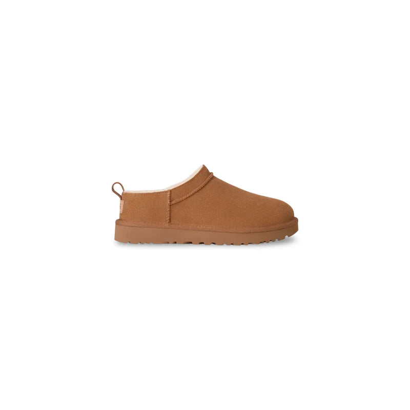 Tan suede ugg women leather slip on shoes with plush shearling lining and rubber sole for spring summer use