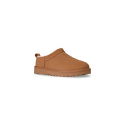 Tan ugg women leather slip on shoe in beige with plush interior and chunky sole for spring summer wear