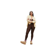 A woman wearing UGG women’s beige suede ankle boots with platform soles paired with fall winter attire