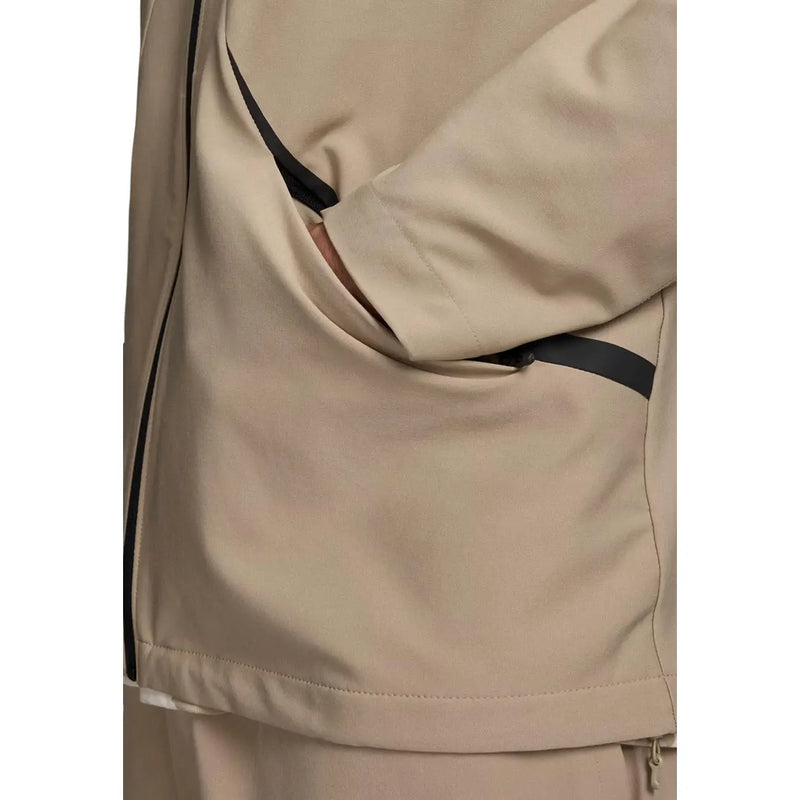 Under Armour Sweat à capuche zippé beige pour homme, en tissu tissé, avec détails de fermeture éclair noirs et design moderne et élégant.