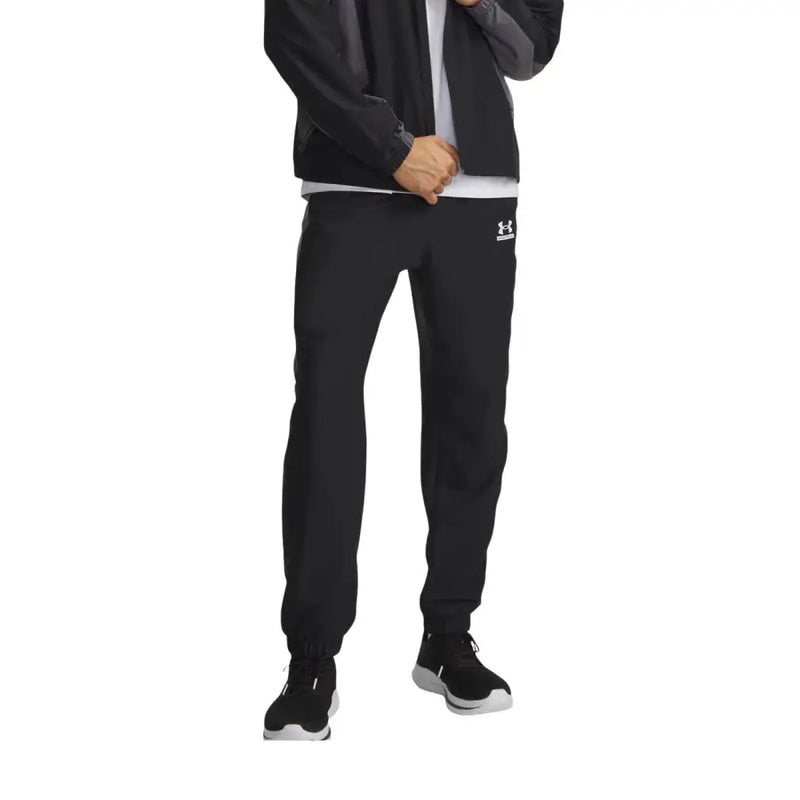 Under armour Pantalon de survêtement noir pour homme avec un logo blanc discret sur la cuisse gauche, idéal pour le sport.