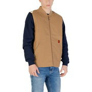 Brown bomber jacket with navy blue sleeves and red patch on sleeve.