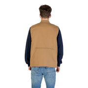 Vue arrière du gilet long zippé beige Vans pour homme, composé d'un gilet utilitaire beige avec poche zippée.