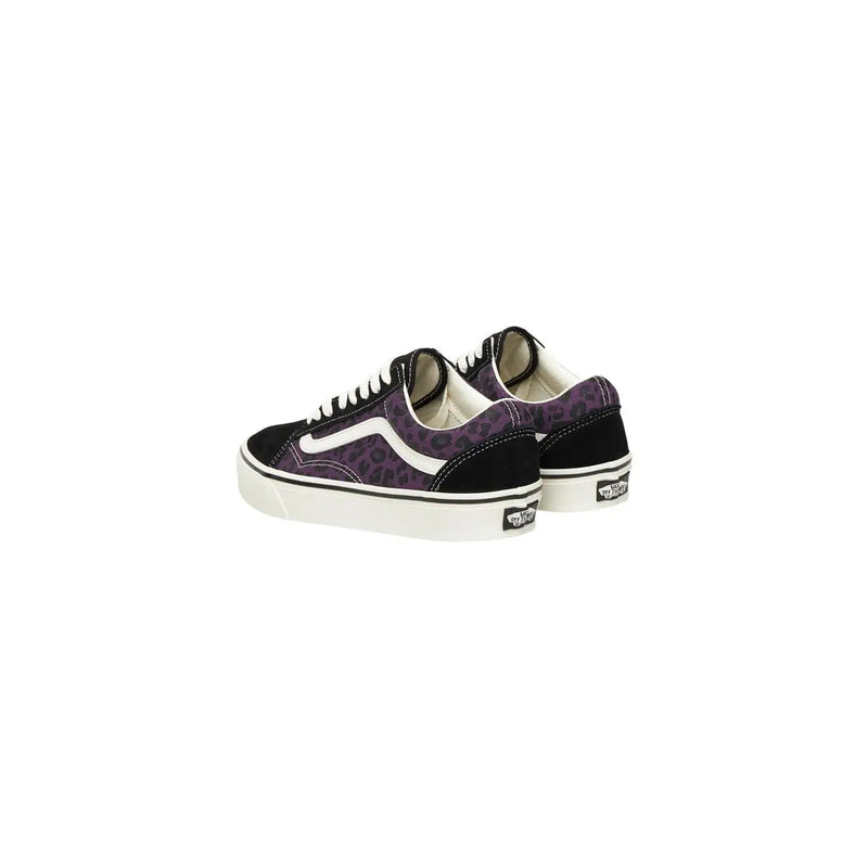 Baskets Vans Old Skool pour homme en cuir noir léopard avec imprimé léopard violet, empiècements en daim noir et semelles en caoutchouc blanc.