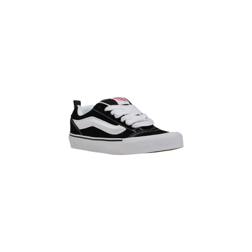 Baskets Vans noires et blanches pour femmes, en cuir, avec tige en toile, semelle en caoutchouc et bande latérale emblématique, parfaites pour l'automne.