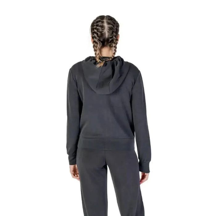 Back view of a dark gray Guess Active hooded sweatshirt with braided hair