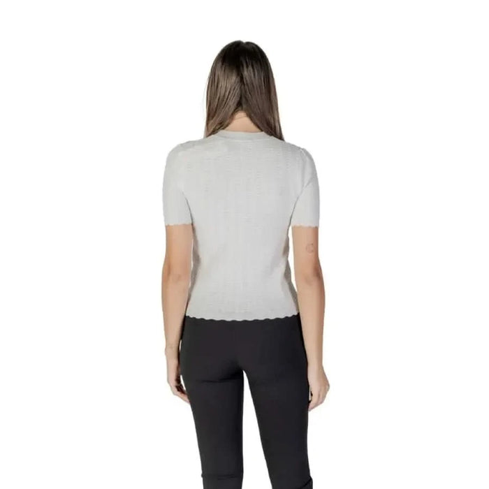 Back view of light gray ribbed top with black pants from Morgan De Toi collection