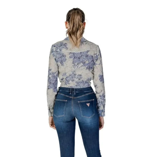 Back view of a person in a Guess Women’s Floral Blue Long Sleeve Shirt and jeans
