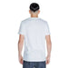 Back view of a person wearing a plain white Peuterey Men T-Shirt and blue jeans