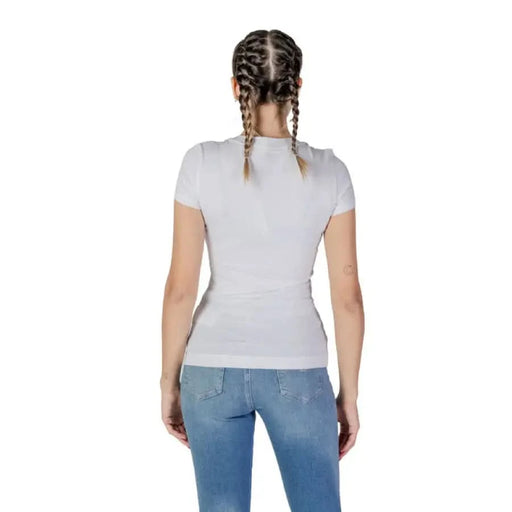 Back view of a person in Guess Women’s White Round Neck T-Shirt and blue jeans