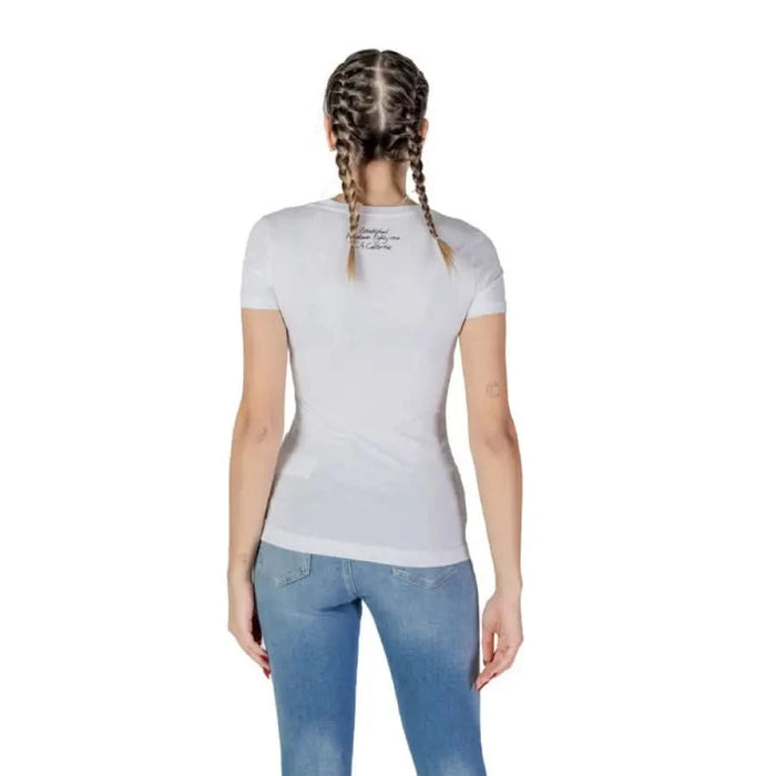 Back view of a person in a Guess Women’s Round Neck T-Shirt and blue jeans
