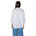 Womens white embellished button-down shirt paired with blue pants for a stylish look