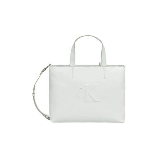 White Calvin Klein leather tote bag displayed prominently in a product image