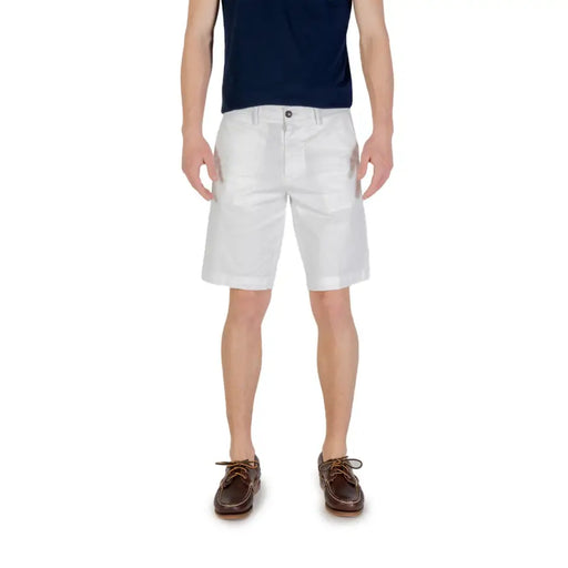 Mens white chino shorts paired with brown boat shoes for a stylish summer look