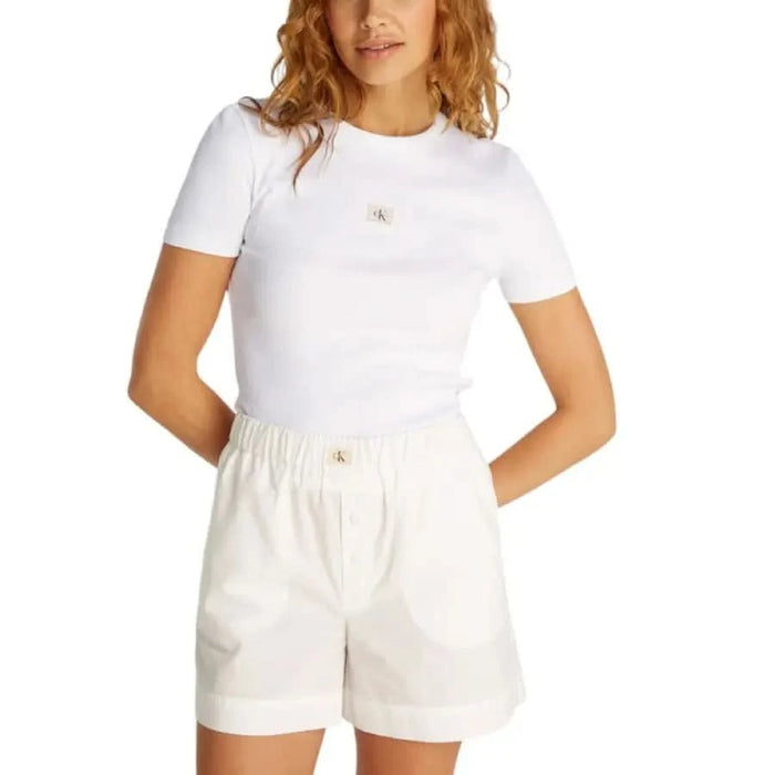 White cotton shorts with elastic waistband and pockets paired with Calvin Klein Jeans T-shirt