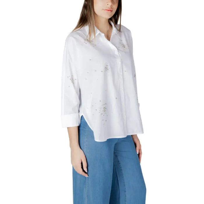 White embellished button-down shirt for women displayed in the product listing