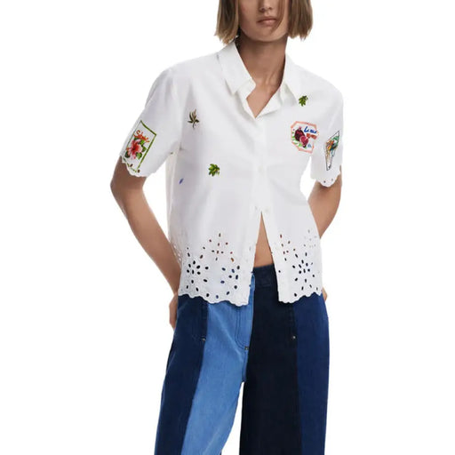White embroidered short-sleeved shirt displayed in a product listing