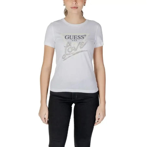 White Guess logo t-shirt with metallic silver lettering styled with black pants