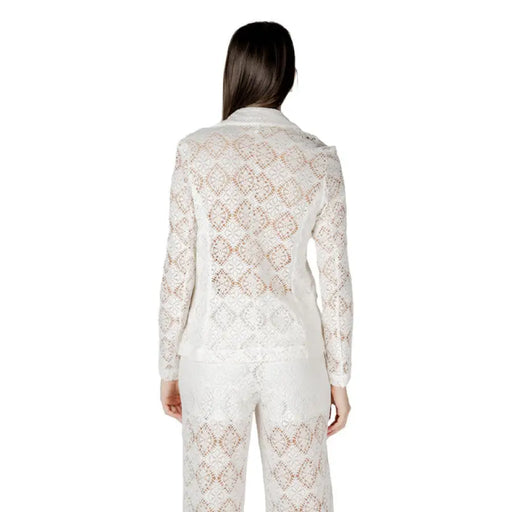 White lace blazer and pants set displayed on a mannequin for elegant formal wear