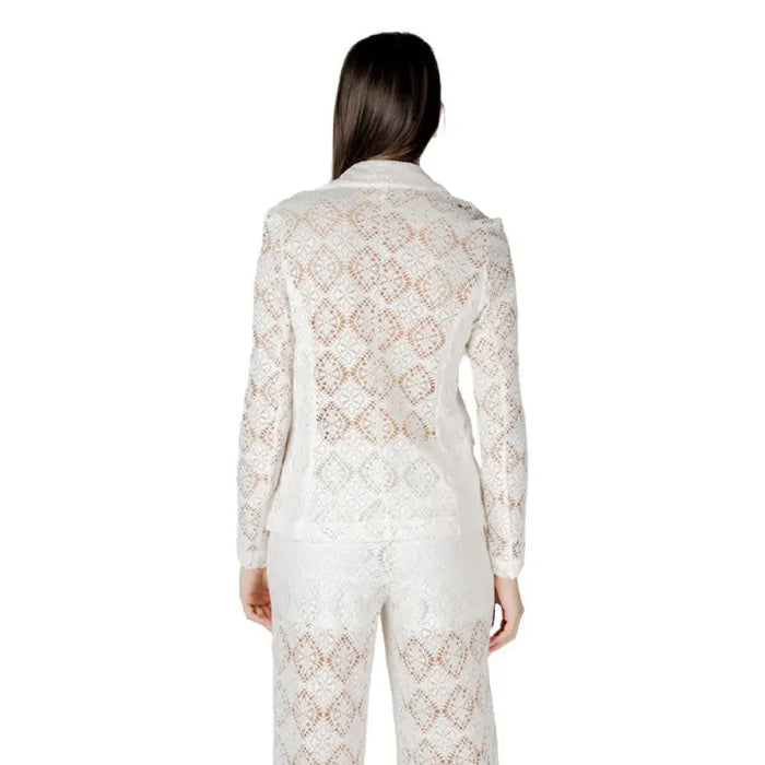 White lace blazer and pants set displayed on a mannequin for elegant formal wear