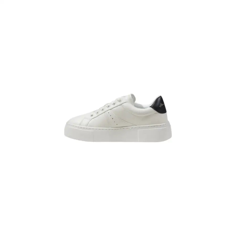 White leather low-top sneaker with black heel accent and thick white platform sole shown from the back side