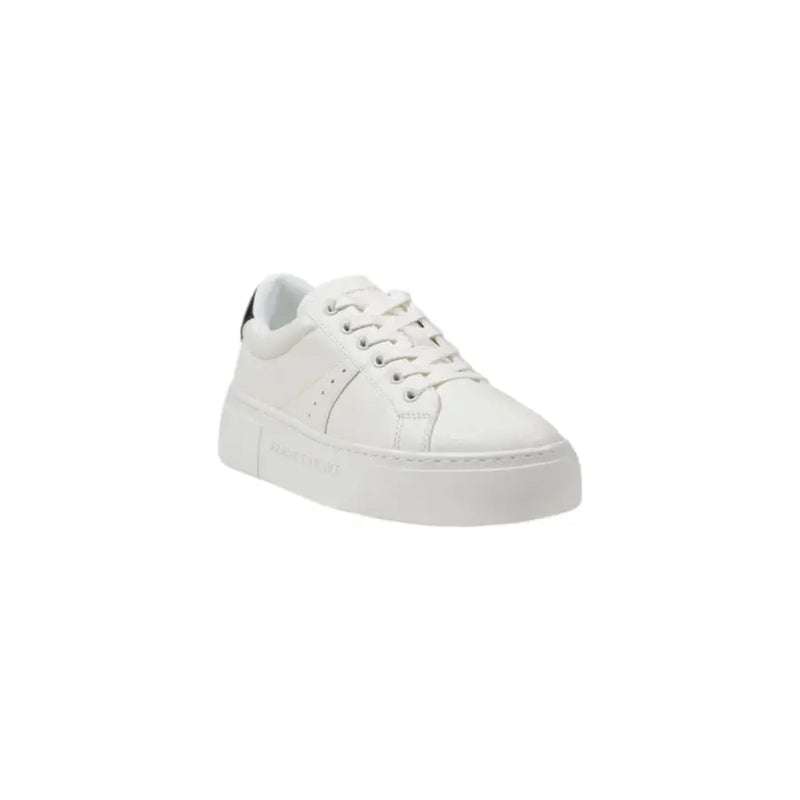 White leather low-top sneakers with a thick platform sole and subtle black heel accent shown from the back side