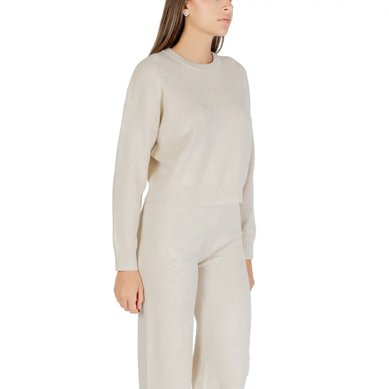 Cream-colored ribbed knit sweater for women with long sleeves and a round crew neckline