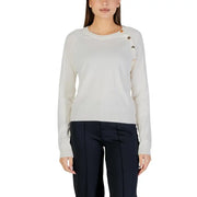 Cream-colored long sleeve round neck knit top for women with subtle textured knit and decorative shoulder buttons