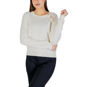 White long sleeve round neck knit top for women in cream color with wooden buttons along the shoulder seam
