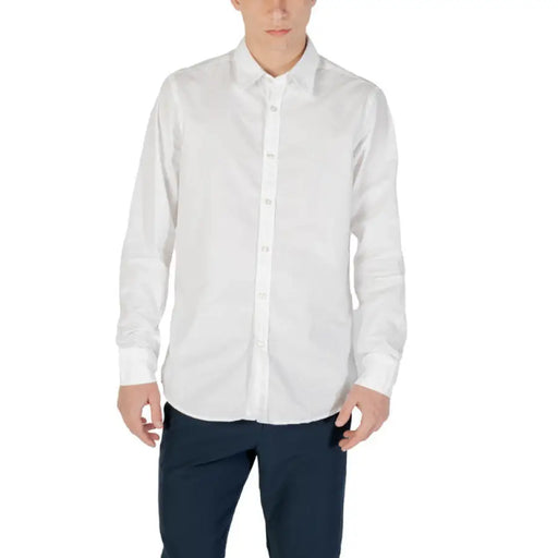 White long-sleeved button-down shirt displayed with dark pants in product image