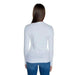 Back view of a long-haired woman wearing Guess Women’s Knitwear white long-sleeved sweater