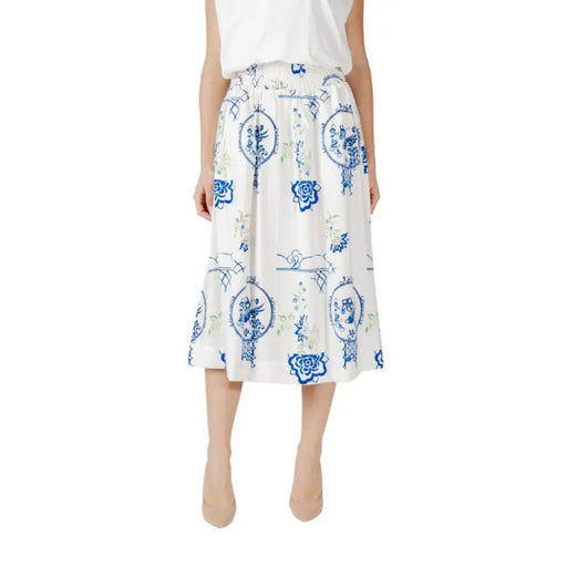 White midi skirt featuring a blue floral pattern ideal for elegant summer outfits