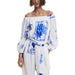 White off-the-shoulder jumpsuit with blue floral tile print for elegant summer wear